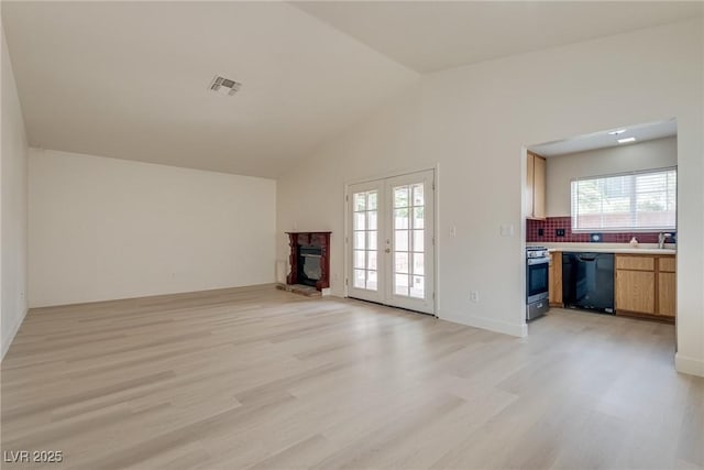 4630 Pratt Way, Las Vegas, NV 89147 - unfurnished living room featuring a fireplace, light wood finished floors, plenty of natural light, and vaulted ceiling