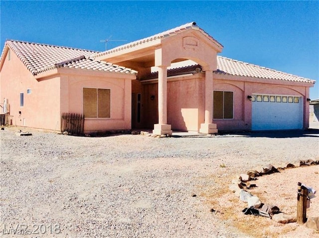 1710 N Murphy St, Pahrump, NV 89060 - view of front of property with a tile roof, an attached garage, stucco siding, and driveway
