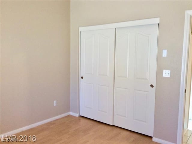 1710 N Murphy St, Pahrump, NV 89060 - unfurnished bedroom with light wood-style floors and a closet
