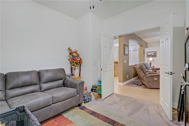 7013 Bisoni St, Las Vegas, NV 89149 - living area with light carpet, arched walkways, and a ceiling fan