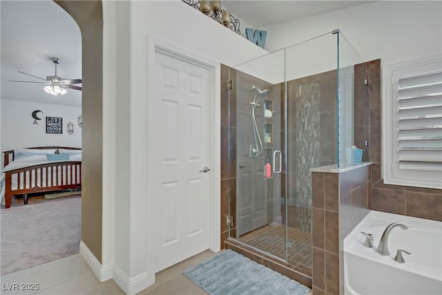 7013 Bisoni St, Las Vegas, NV 89149 - bathroom featuring a bath, a shower stall, tile patterned floors, a ceiling fan, and connected bathroom