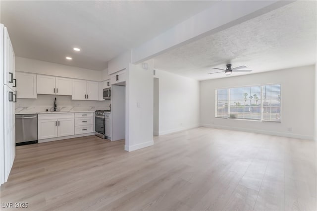 2 Utah Way, Henderson, NV 89015 - kitchen with appliances with stainless steel finishes, open floor plan, ceiling fan, light wood-style floors, and recessed lighting