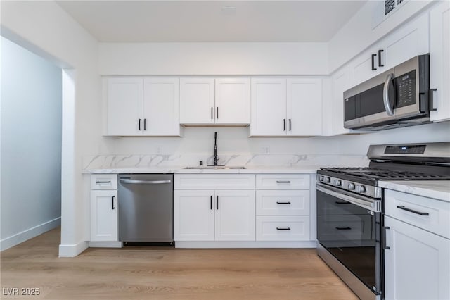 2 Utah Way, Henderson, NV 89015 - kitchen with appliances with stainless steel finishes, white cabinets, and light stone countertops