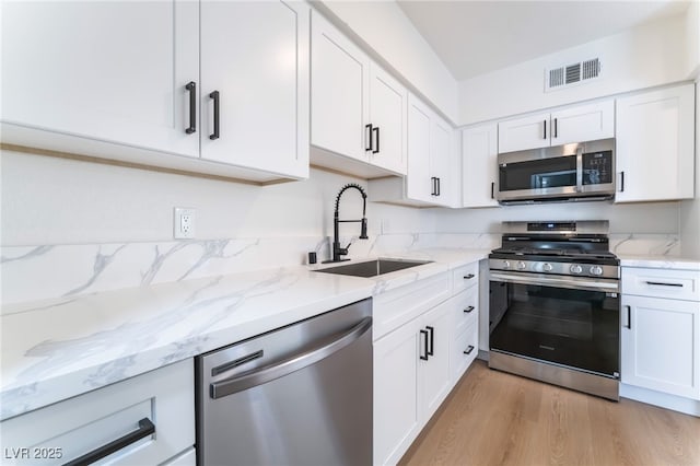 2 Utah Way, Henderson, NV 89015 - kitchen featuring appliances with stainless steel finishes and white cabinets