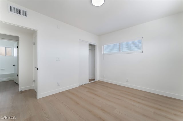 2 Utah Way, Henderson, NV 89015 - unfurnished bedroom with light wood-style flooring, multiple windows, and a closet