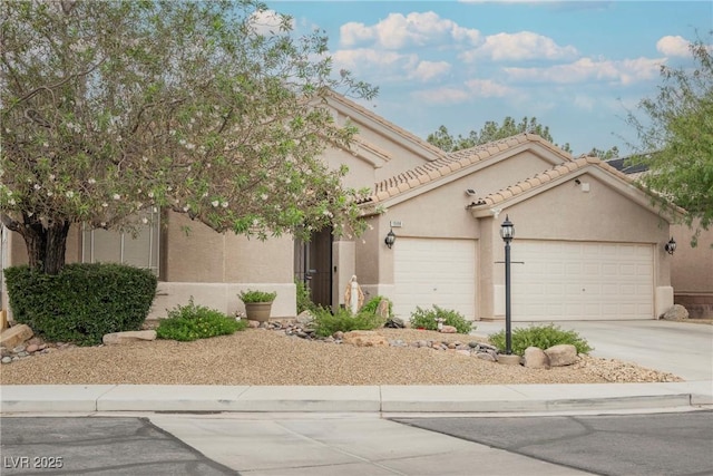 1598 Cowboy Chaps Pl, Henderson, NV 89002 - view of front facade featuring a garage, concrete driveway, stucco siding, and a tiled roof