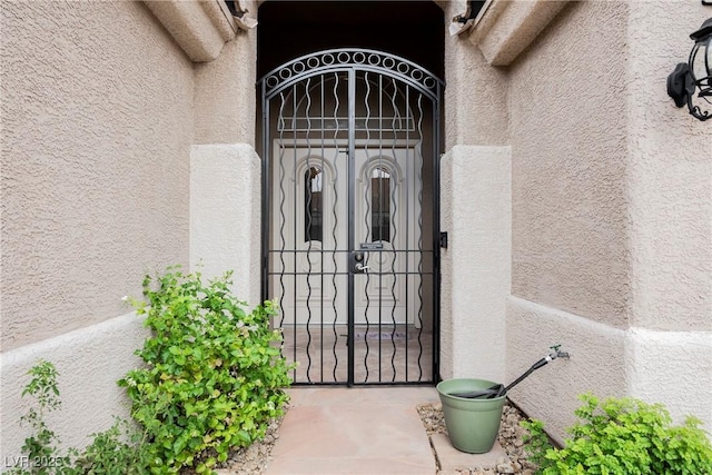 1598 Cowboy Chaps Pl, Henderson, NV 89002 - view of exterior entry with stucco siding and a gate