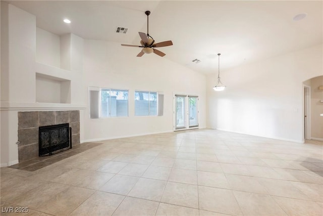 1598 Cowboy Chaps Pl, Henderson, NV 89002 - unfurnished living room with ceiling fan, a tiled fireplace, light tile patterned floors, high vaulted ceiling, and recessed lighting