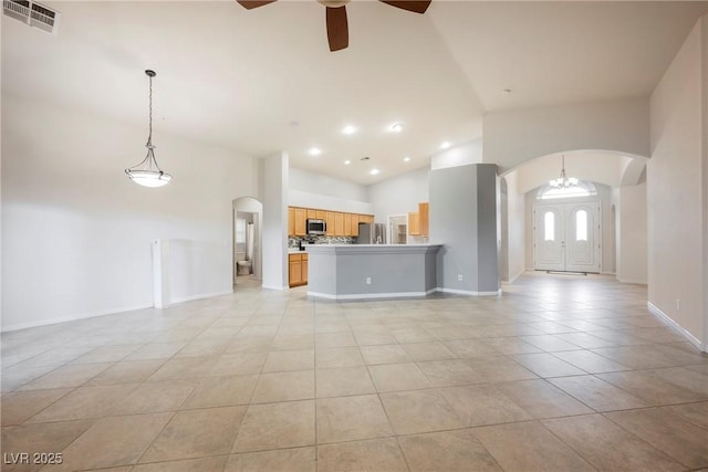 1598 Cowboy Chaps Pl, Henderson, NV 89002 - unfurnished living room with arched walkways, high vaulted ceiling, ceiling fan, light tile patterned floors, and recessed lighting