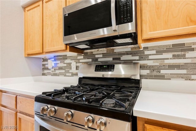 1598 Cowboy Chaps Pl, Henderson, NV 89002 - kitchen with appliances with stainless steel finishes, light brown cabinetry, and tasteful backsplash
