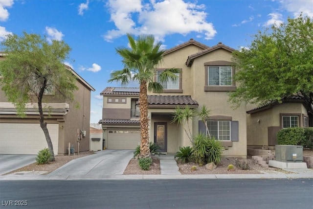 8325 Winterchase Pl, Las Vegas, NV 89143 - view of front of house featuring stucco siding, a tiled roof, driveway, and roof mounted solar panels