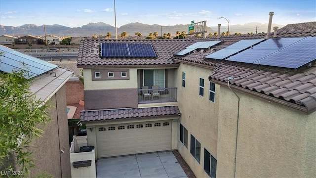 8325 Winterchase Pl, Las Vegas, NV 89143 - rear view of house with a mountain view, a tiled roof, and stucco siding
