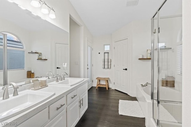 8325 Winterchase Pl, Las Vegas, NV 89143 - full bath with a bath, double vanity, a shower stall, and wood finished floors
