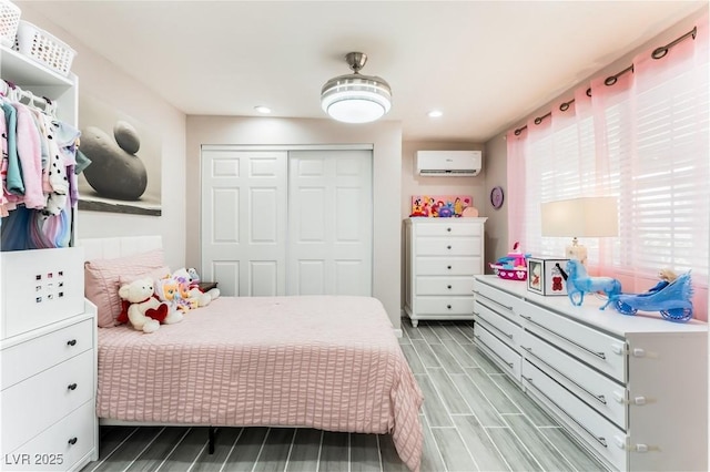 2093 Seahurst Dr, Las Vegas, NV 89142 - bedroom with a closet, wood finish floors, recessed lighting, and a wall mounted air conditioner