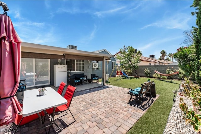 2093 Seahurst Dr, Las Vegas, NV 89142 - fenced backyard featuring a patio area, a playground, and outdoor dining area