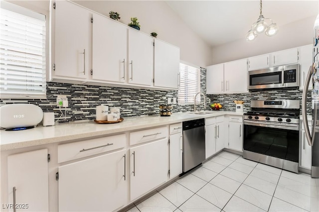 2093 Seahurst Dr, Las Vegas, NV 89142 - kitchen featuring stainless steel appliances, decorative backsplash, white cabinetry, light countertops, and light tile patterned floors