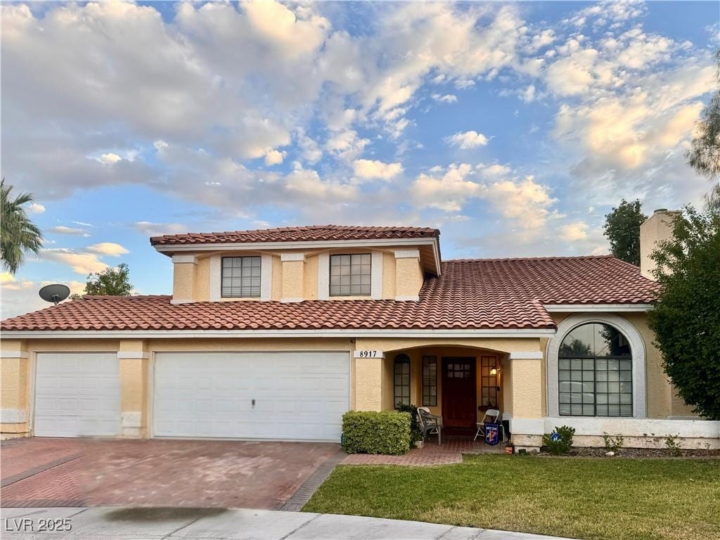 8917 Montego Bay Dr, Las Vegas, NV 89117 - mediterranean / spanish home with decorative driveway, a front lawn, a tile roof, and stucco siding