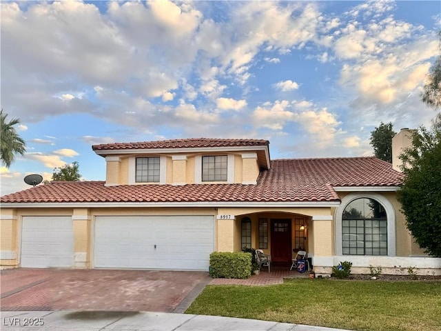 8917 Montego Bay Dr, Las Vegas, NV 89117 - mediterranean / spanish home with decorative driveway, a front lawn, a tile roof, and stucco siding