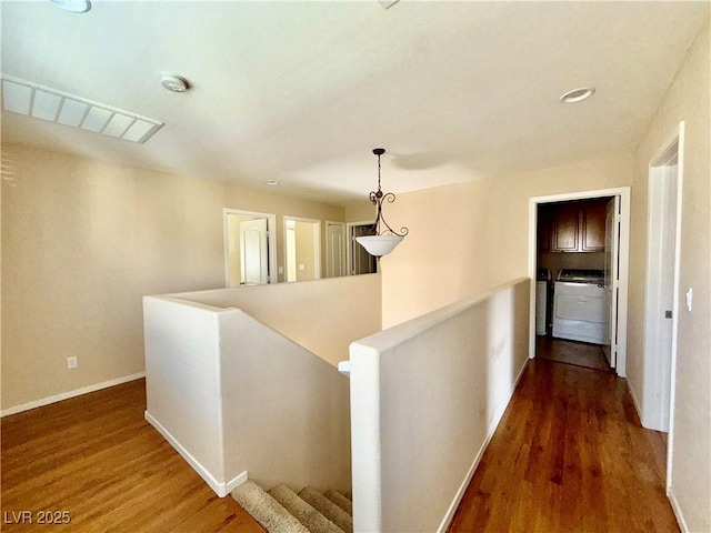 5517 Overlook Valley St, North Las Vegas, NV 89081 - hall with an upstairs landing, wood finished floors, and washing machine and clothes dryer