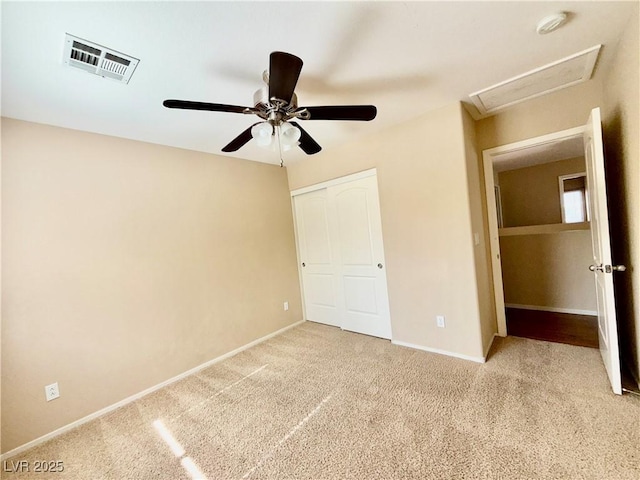 5517 Overlook Valley St, North Las Vegas, NV 89081 - unfurnished bedroom with light carpet, a closet, attic access, and ceiling fan