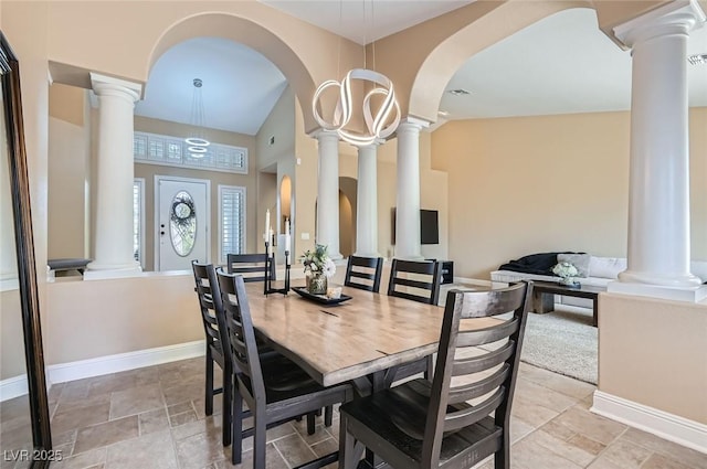 7404 Wittig Ave, Las Vegas, NV 89131 - dining area featuring ornate columns, arched walkways, light stone finish floors, and lofted ceiling
