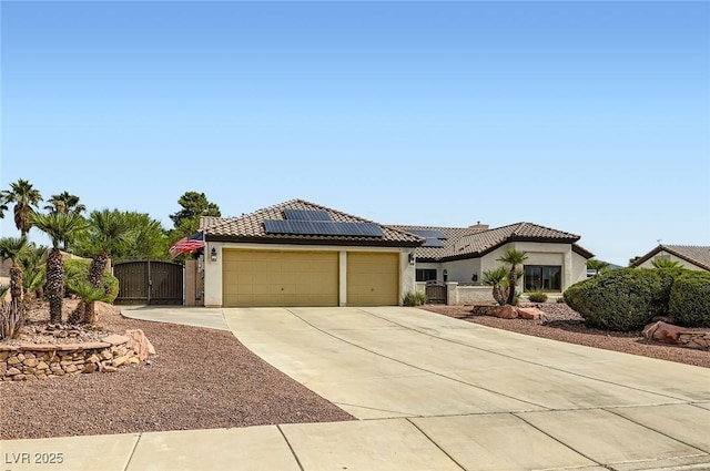 7404 Wittig Ave, Las Vegas, NV 89131 - mediterranean / spanish house featuring a gate, stucco siding, driveway, and a garage