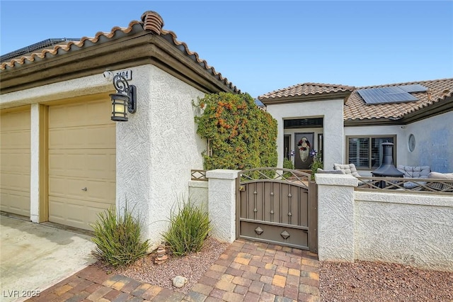 7404 Wittig Ave, Las Vegas, NV 89131 - view of front facade featuring a gate, stucco siding, a fenced front yard, and a tiled roof