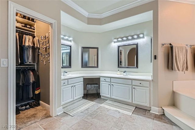 7404 Wittig Ave, Las Vegas, NV 89131 - full bathroom featuring crown molding, double vanity, a spacious closet, and stone finish floors