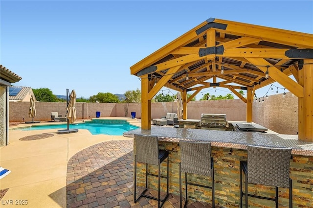 7404 Wittig Ave, Las Vegas, NV 89131 - view of swimming pool featuring a gazebo, a fenced backyard, an outdoor kitchen, and a patio