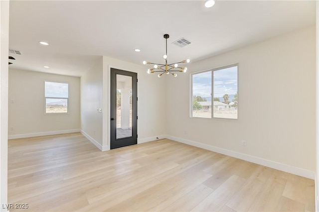 2461 S Blagg Rd, Pahrump, NV 89048 - empty room with a chandelier, recessed lighting, plenty of natural light, and light wood-style floors