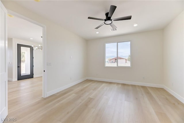 2461 S Blagg Rd, Pahrump, NV 89048 - empty room featuring plenty of natural light, light wood-style floors, recessed lighting, ceiling fan, and a chandelier