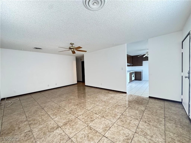 4303 Paramount St, Las Vegas, NV 89115 - spare room with a textured ceiling, a ceiling fan, and light tile patterned floors