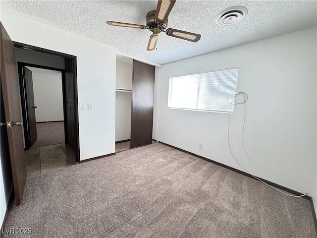4303 Paramount St, Las Vegas, NV 89115 - unfurnished bedroom with a textured ceiling, carpet floors, a closet, and a ceiling fan