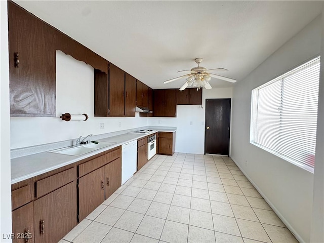 4303 Paramount St, Las Vegas, NV 89115 - kitchen with white appliances, light countertops, ceiling fan, under cabinet range hood, and light tile patterned floors