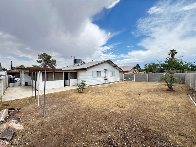 4303 Paramount St, Las Vegas, NV 89115 - back of house with a fenced backyard, a patio, and a sunroom