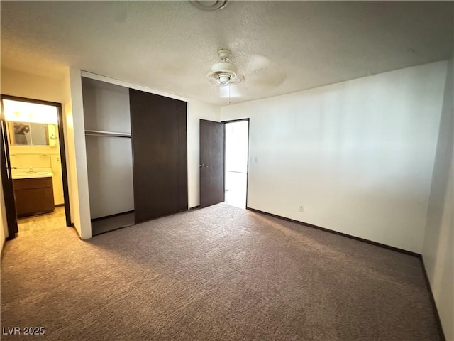 4303 Paramount St, Las Vegas, NV 89115 - unfurnished bedroom with light colored carpet, a closet, a textured ceiling, ensuite bath, and a ceiling fan