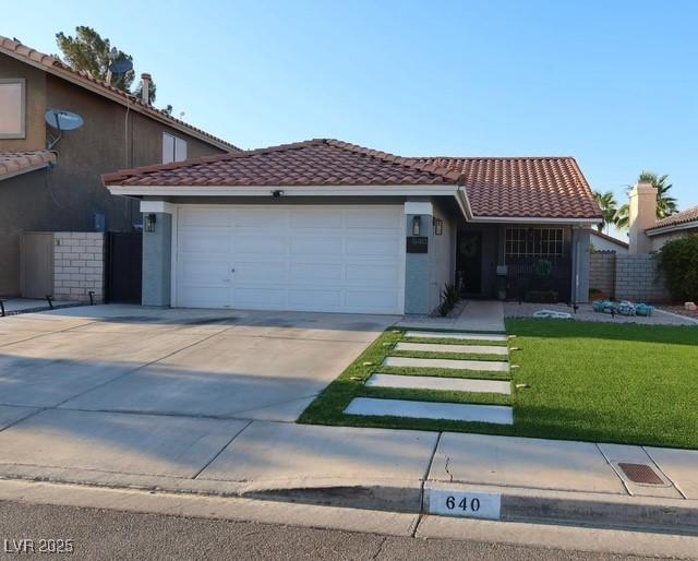 640 Thornewood Pl, Las Vegas, NV 89123 - view of front of property with a garage, a tile roof, stucco siding, and driveway
