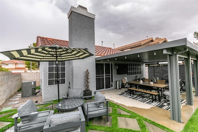 640 Thornewood Pl, Las Vegas, NV 89123 - back of house with a chimney, a tiled roof, stucco siding, a patio area, and outdoor dining area
