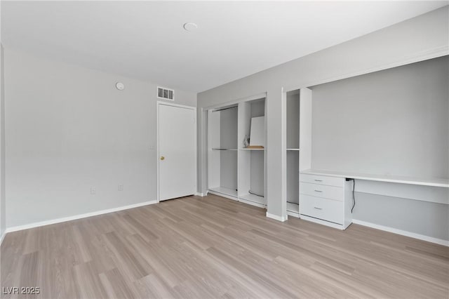 5710 E Tropicana Ave Unit 1184, Las Vegas, NV 89122 - unfurnished bedroom with light wood finished floors and built in desk