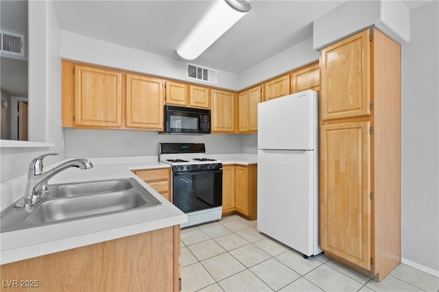 5710 E Tropicana Ave Unit 1184, Las Vegas, NV 89122 - kitchen with white appliances, light brown cabinetry, light countertops, and light tile patterned floors