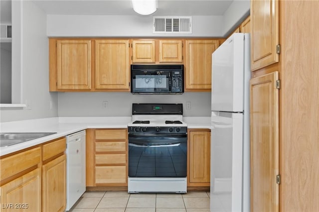 5710 E Tropicana Ave Unit 1184, Las Vegas, NV 89122 - kitchen featuring white appliances, light brown cabinetry, light tile patterned flooring, and light countertops