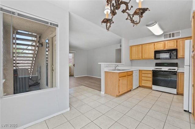 5710 E Tropicana Ave Unit 1184, Las Vegas, NV 89122 - kitchen with white appliances, a peninsula, plenty of natural light, and light countertops