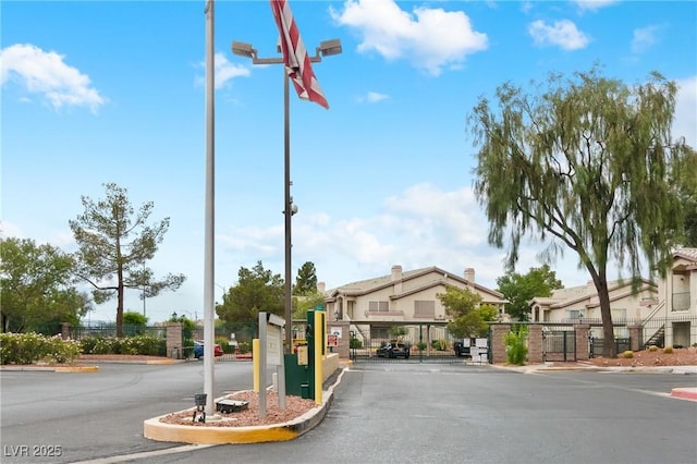 5710 E Tropicana Ave Unit 1184, Las Vegas, NV 89122 - view of asphalt street with curbs and a gated entry