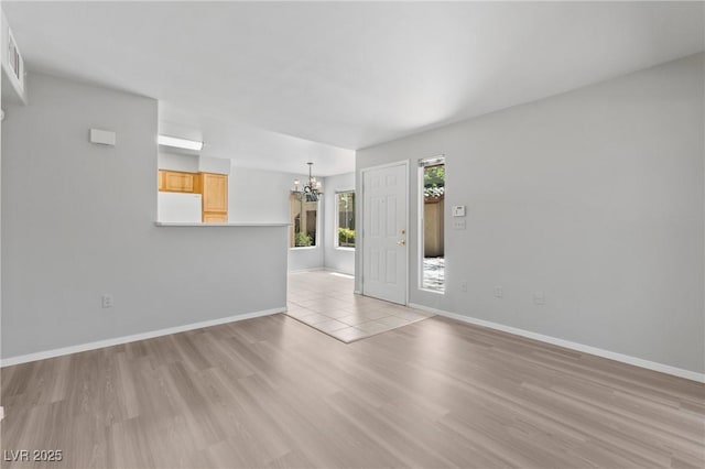 5710 E Tropicana Ave Unit 1184, Las Vegas, NV 89122 - unfurnished room with a chandelier and light wood-type flooring