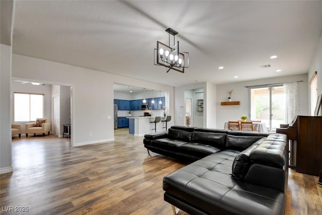 2766 Mintlaw Ave, Henderson, NV 89044 - living room featuring a chandelier, wood finished floors, and recessed lighting