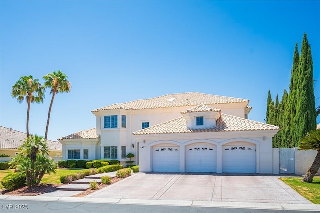 8925 Wild Creek Ct, Las Vegas, NV 89117 - mediterranean / spanish-style home with a garage, stucco siding, a tile roof, and concrete driveway