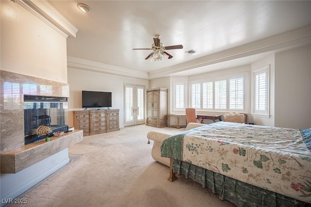 8925 Wild Creek Ct, Las Vegas, NV 89117 - carpeted bedroom with a tiled fireplace, crown molding, a raised ceiling, and a ceiling fan
