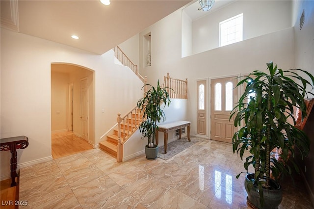 8925 Wild Creek Ct, Las Vegas, NV 89117 - foyer with stairs, healthy amount of natural light, arched walkways, recessed lighting, and a towering ceiling