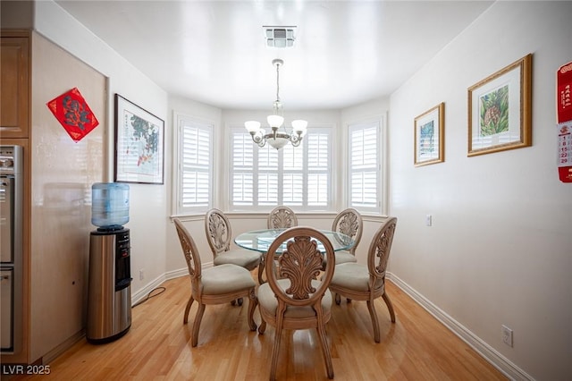 8925 Wild Creek Ct, Las Vegas, NV 89117 - dining area featuring a chandelier, light wood-style floors, and plenty of natural light