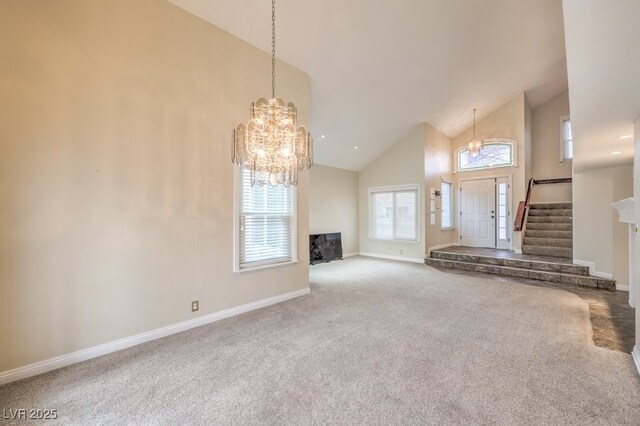 56 Westheimer Rd, Henderson, NV 89074 - unfurnished living room with a chandelier, high vaulted ceiling, carpet flooring, and stairs